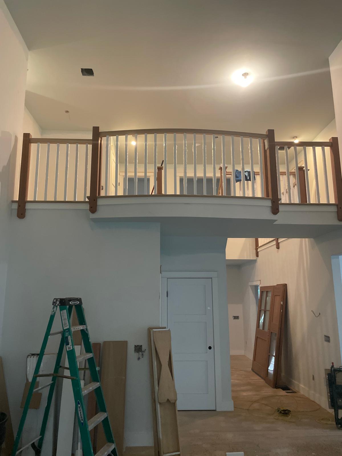 Before and after photo of stair trim installation inside a house by Victor's Finish Work