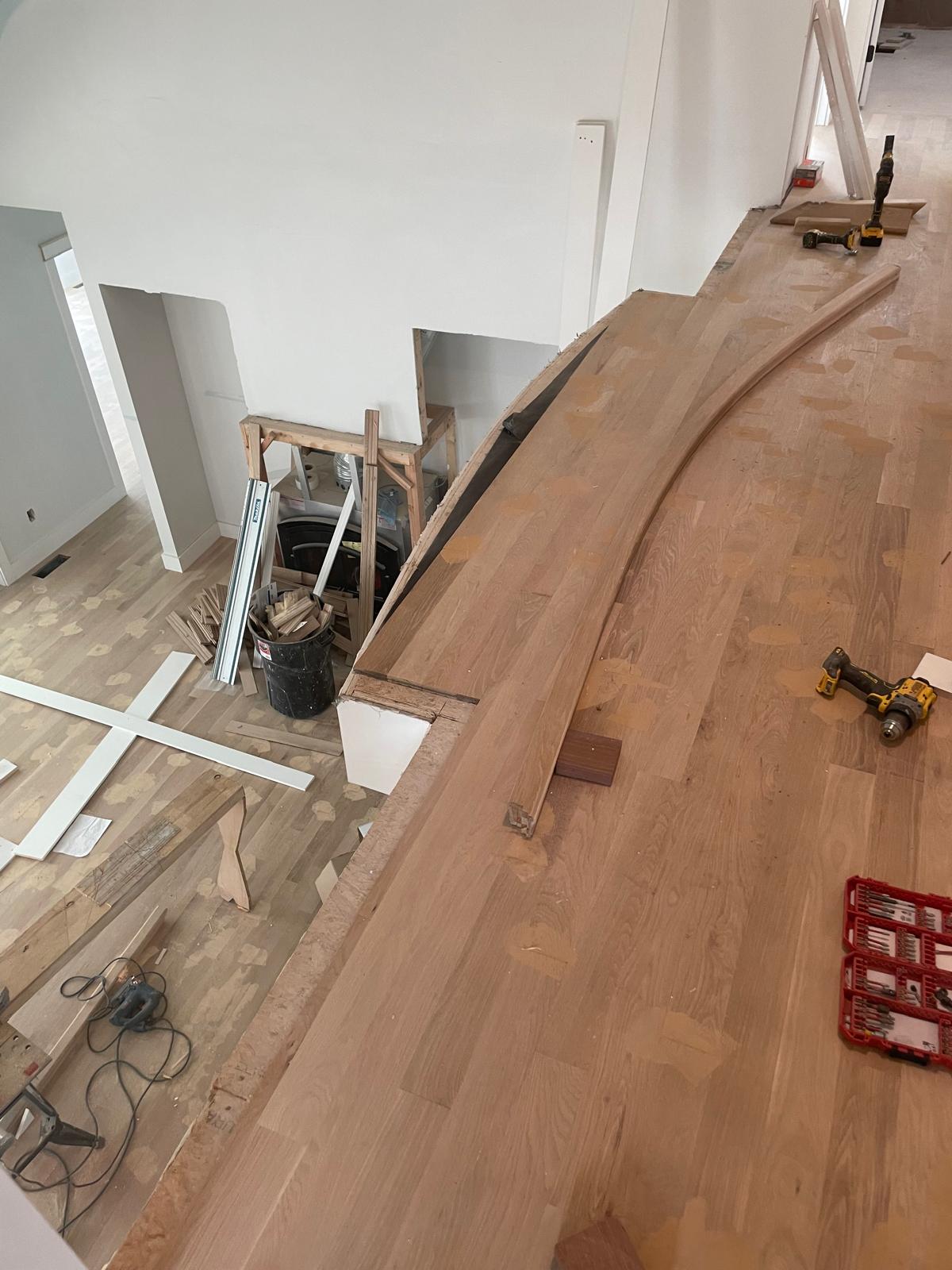 Before and after photo of stair trim installation inside a house by Victor's Finish Work